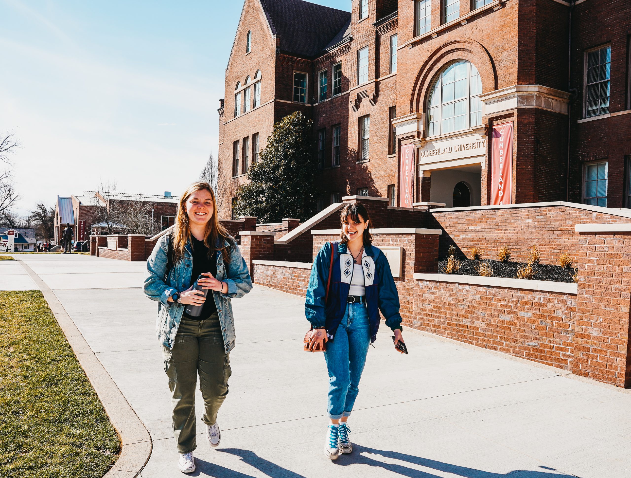 Two students walking in front of Memorial Hall